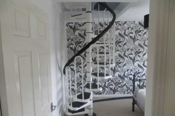 Upstairs spiral staircase from bedroom to create living area in loft space
